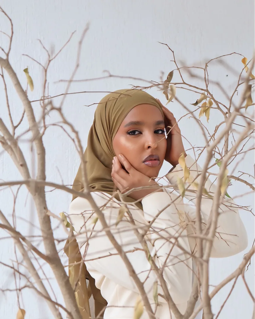 Editorial fashion portrait among bare branches